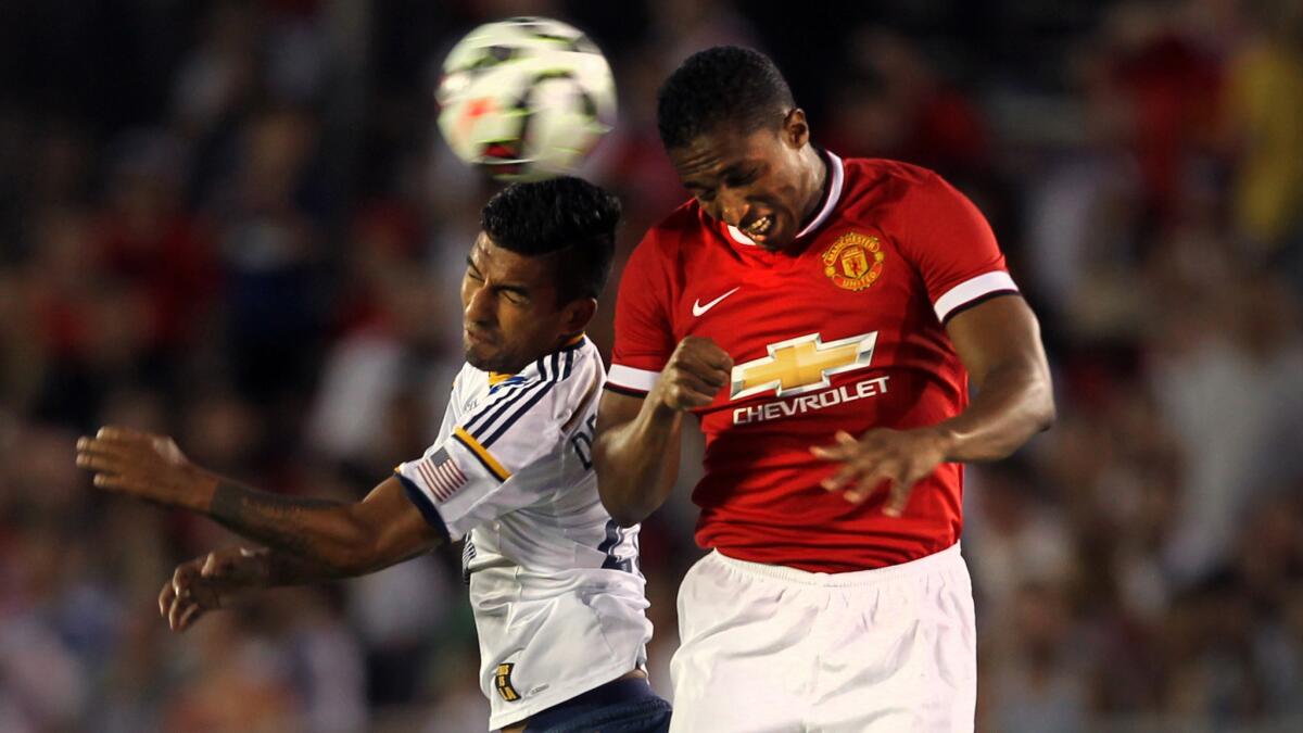 Galaxy defender A.J. Delagarza, left, goes for a header against Manchester United forward Antonio Valencia during Manchester United's 7-0 exhibition victory Wednesday at the Rose Bowl.