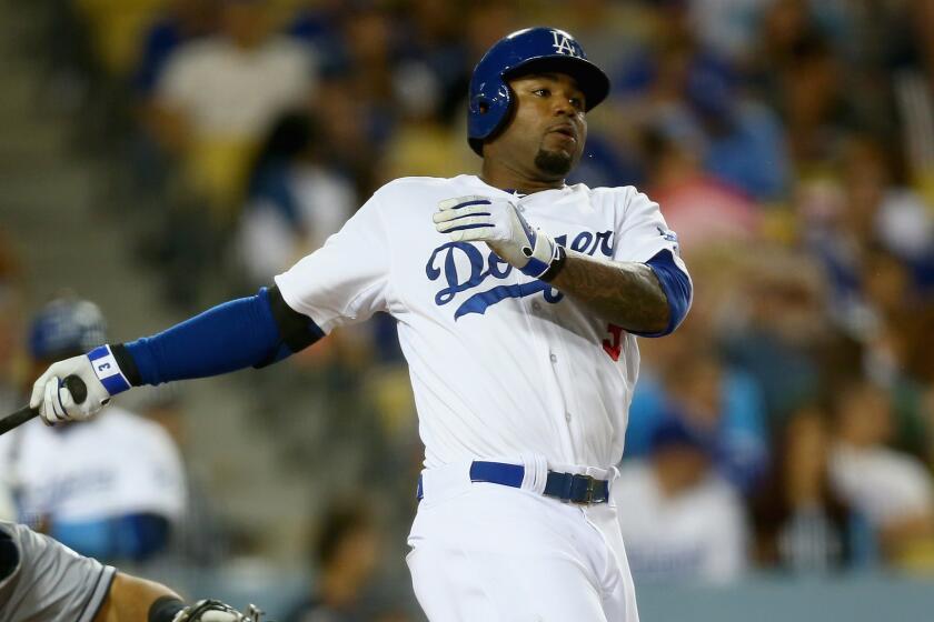 Dodgers left fielder Carl Crawford hits a run-scoring double in the eighth inning of a 4-0 win over the San Diego Padres on Wednesday.