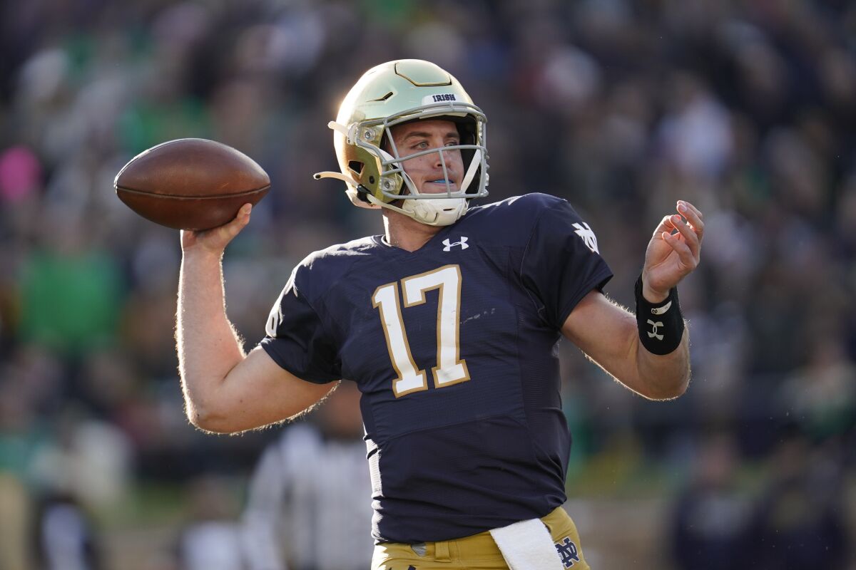 Notre Dame quarterback Jack Coan throws against Navy in the first half of an NCAA college football game in South Bend, Ind., Saturday, Nov. 6, 2021. (AP Photo/Paul Sancya)