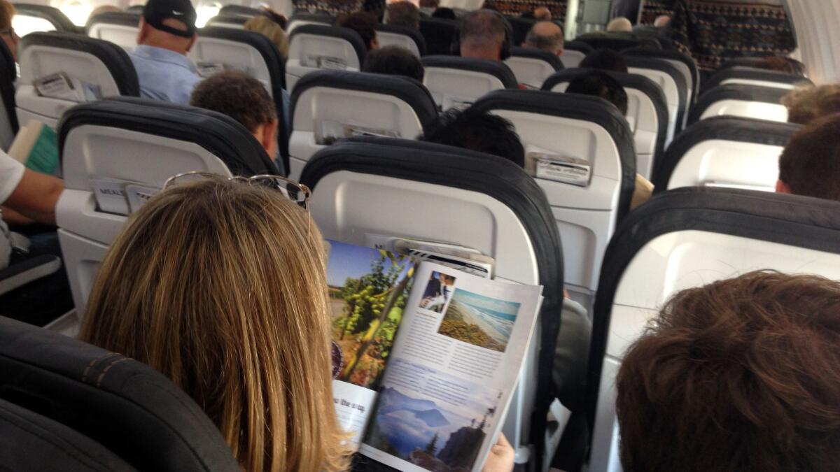 Passengers fill an Alaska Airlines flight. The Seattle-based carrier plans to launch a bare-bones fare that limits passengers' seat choices.