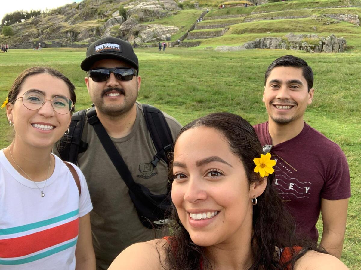 Evelin Pineda, her brother and friends pose for a selfie in Peru. 