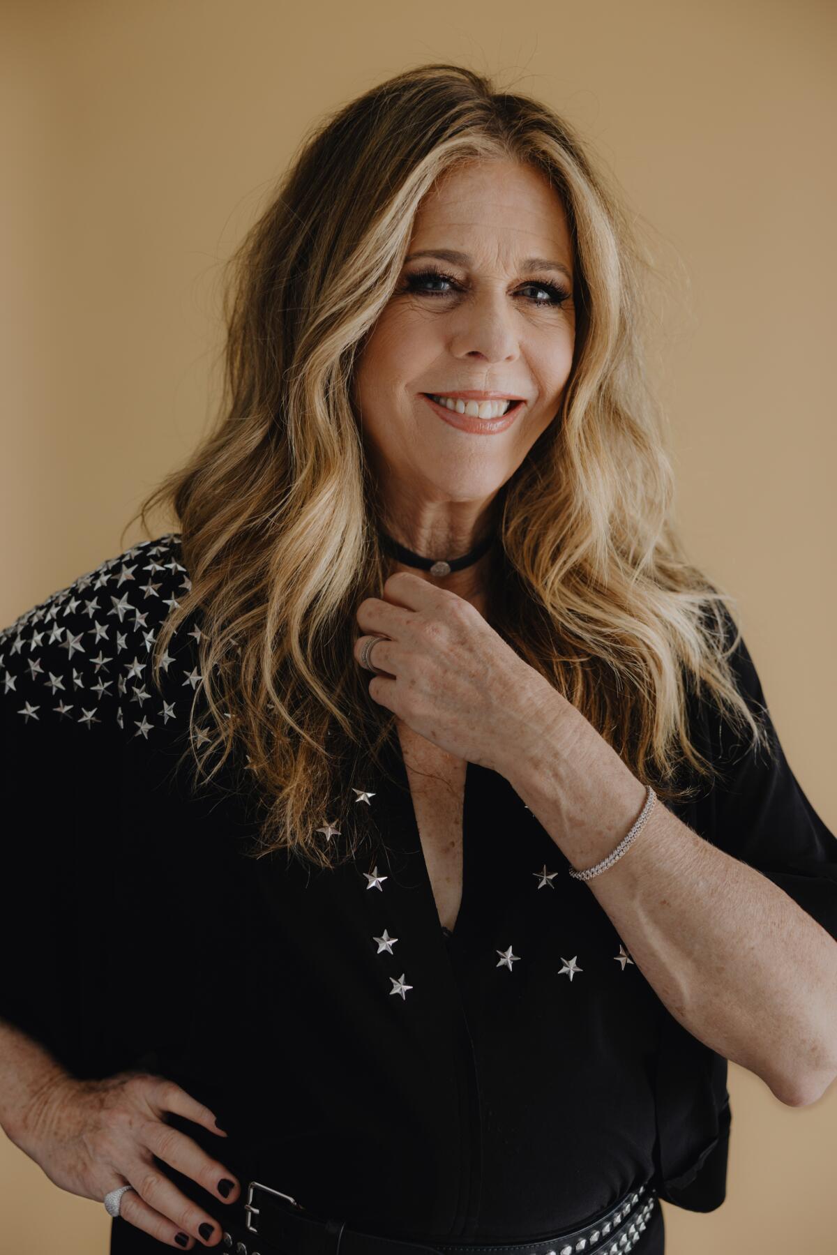 Rita Wilson wears a black top with stars for a portrait.