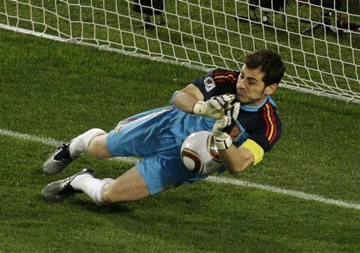 Spain goalkeeper Iker Casillas makes a save on a penalty kick by Paraguay's Oscar Cardozo, not visible, during the World Cup quarterfinal soccer match between Paraguay and Spain at Ellis Park Stadium in Johannesburg, South Africa, Saturday, July 3, 2010. (AP Photo/Themba Hadebe)