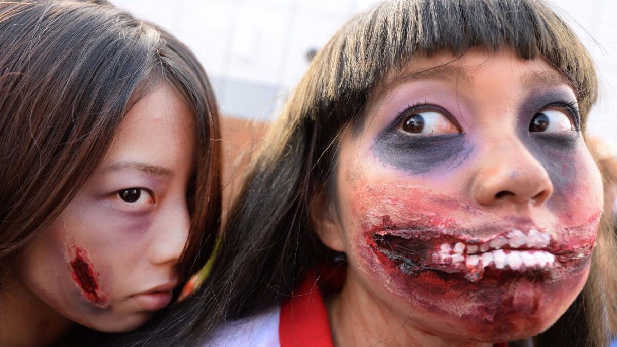 Participants pose for pictures in the Halloween Parade in Kawasaki, a suburb of Tokyo,