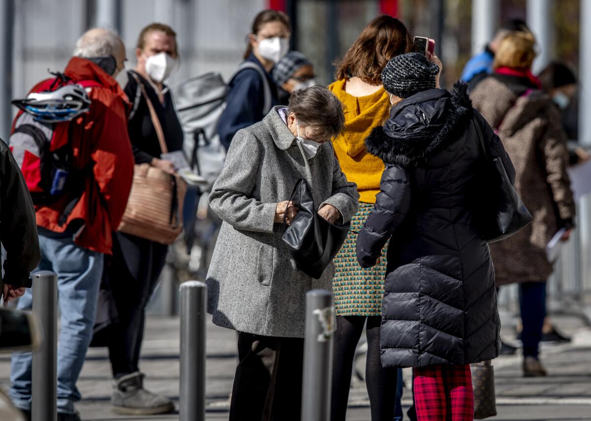 German people stand in an outdoor line