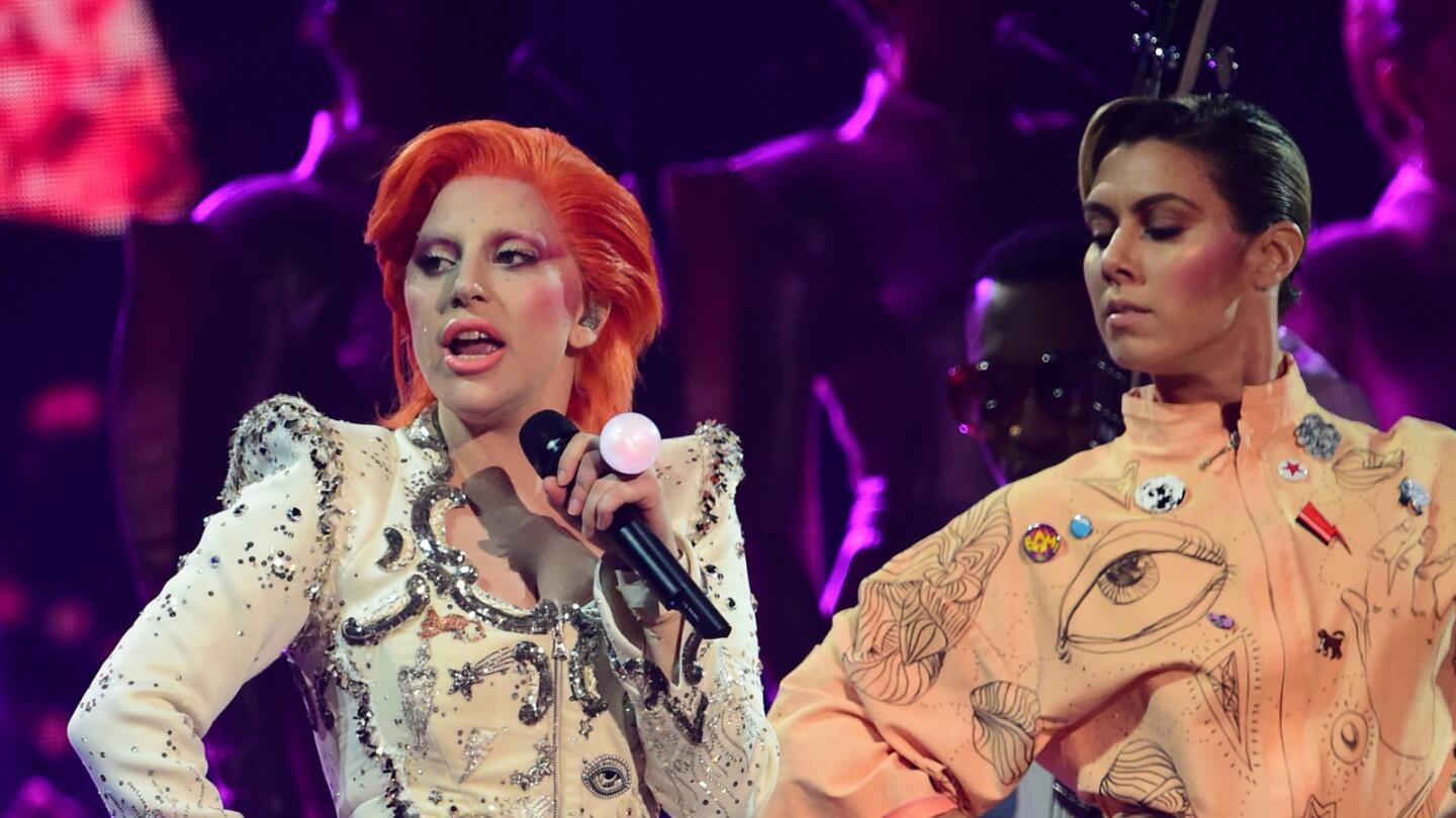 Lady Gaga pays tribute to David Bowie by singing through nearly half a dozen of his songs, including "Ziggy Stardust," "Fashion" and "Heroes."
