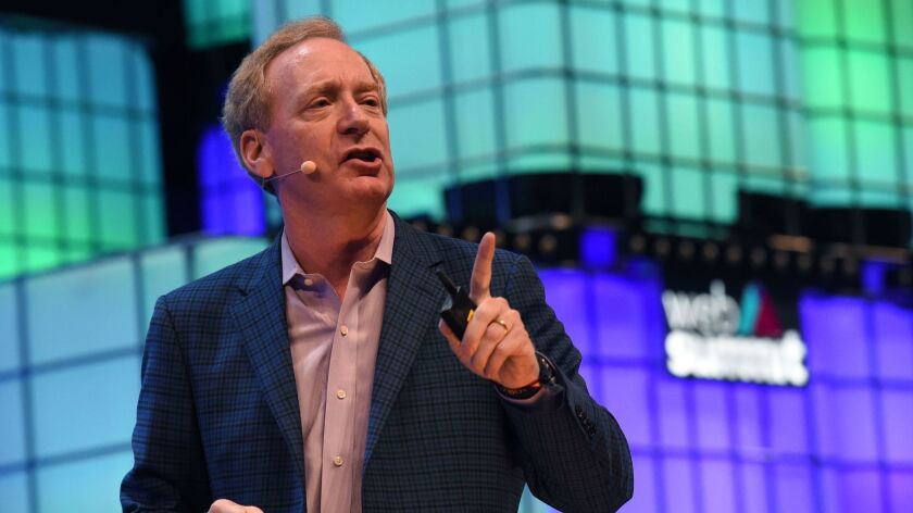 Microsoft President Brad Smith, shown Nov. 7, said Saturday that his company would work with the military on technology development.