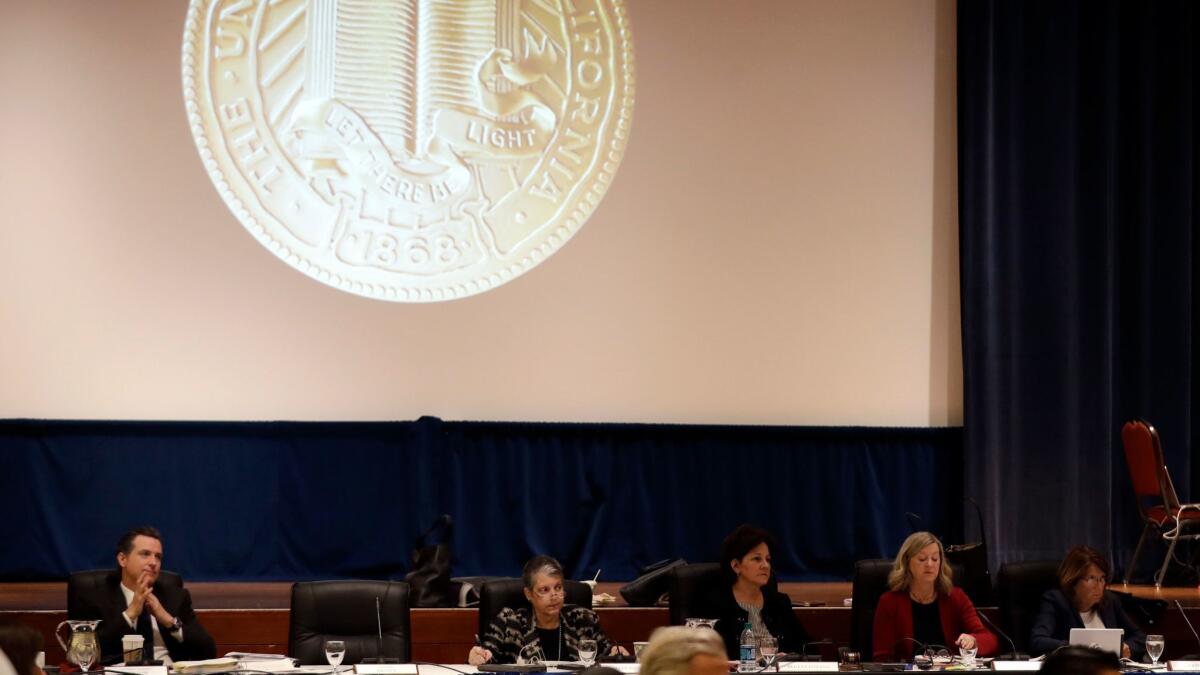 Members of the University of California Board of Regents listen to testimony from employees and students on Thursday. The regents approved a 2.5% tuition increase, the first since 2010-11.