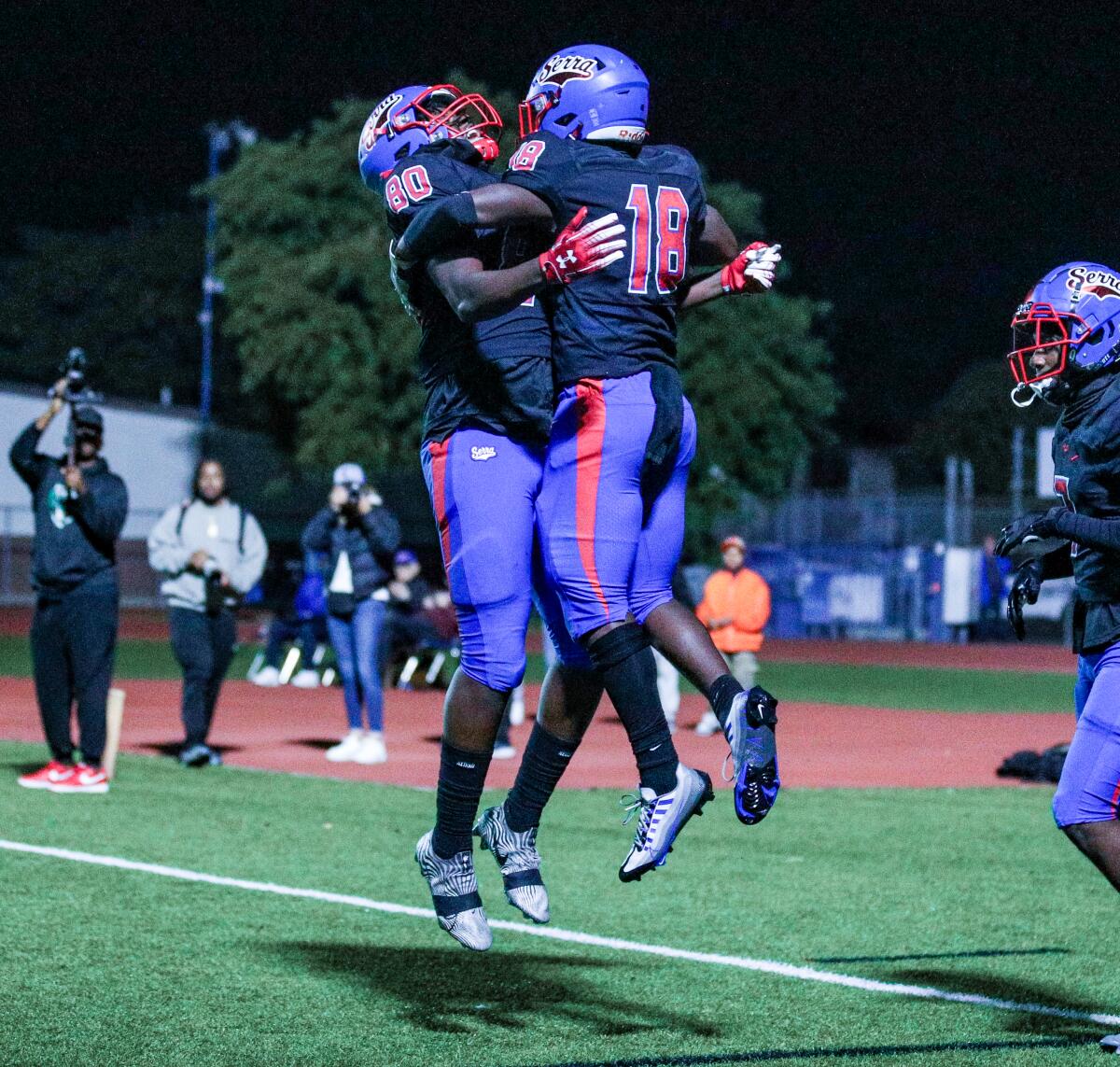 Andre Nickerson (left) and Ty Law celebrate during Gardena Serra's 38-28 win over Los Alamitos.