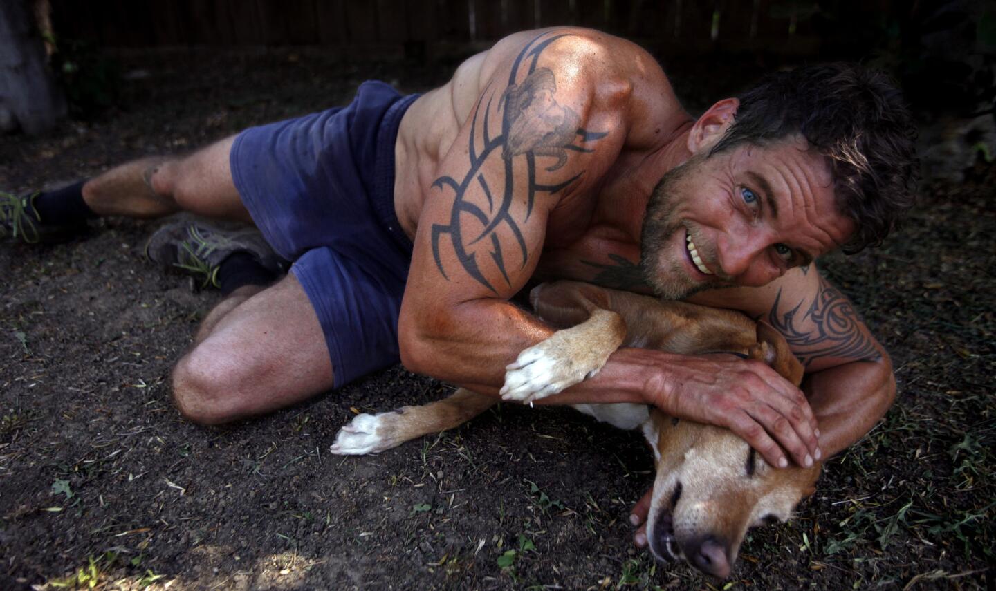Actor Damien Puckler spends a warm moment with his dog Roxy in the backyard of his home in Van Nuys. Puckler most recently can be seen in the television series "Grimm." He has been in the films "30,000 Leagues Under the Sea," "The Man Who Cried" and "Death Factory."