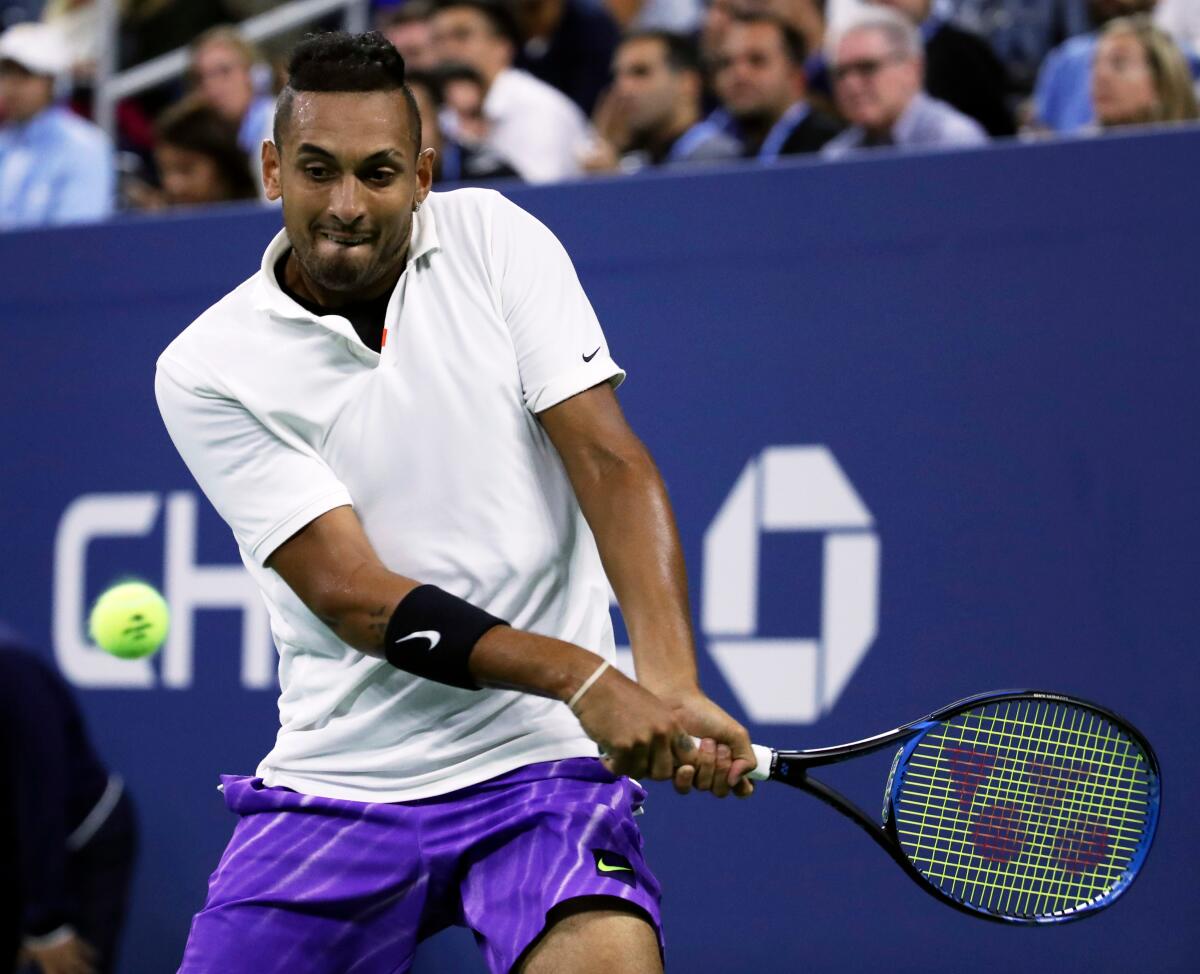 Nick Kyrgios returns to Steve Johnson on the second day of the US Open Tennis Championships on Tuesday in New York.