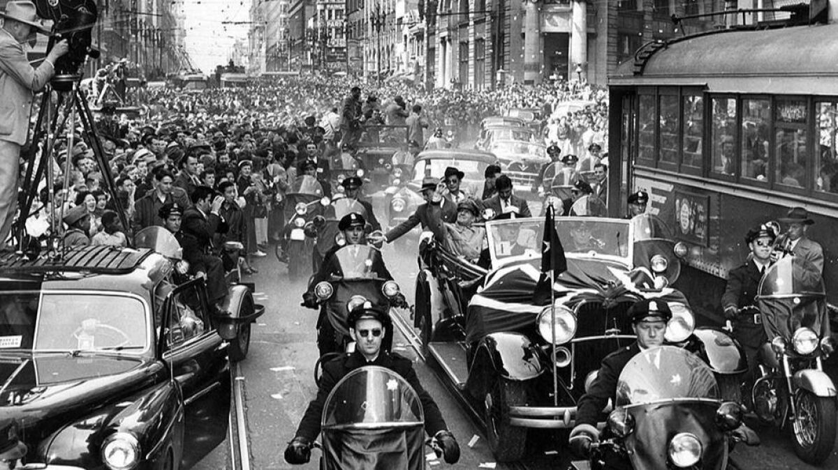 April 18, 1951: Gen. Douglas MacArthur waves during a welcome-home parade in San Francisco.