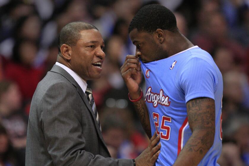 Clippers Coach Doc Rivers talks with Clippers guard Reggie Bullock during a game against Chicago on Nov. 24, 2013.