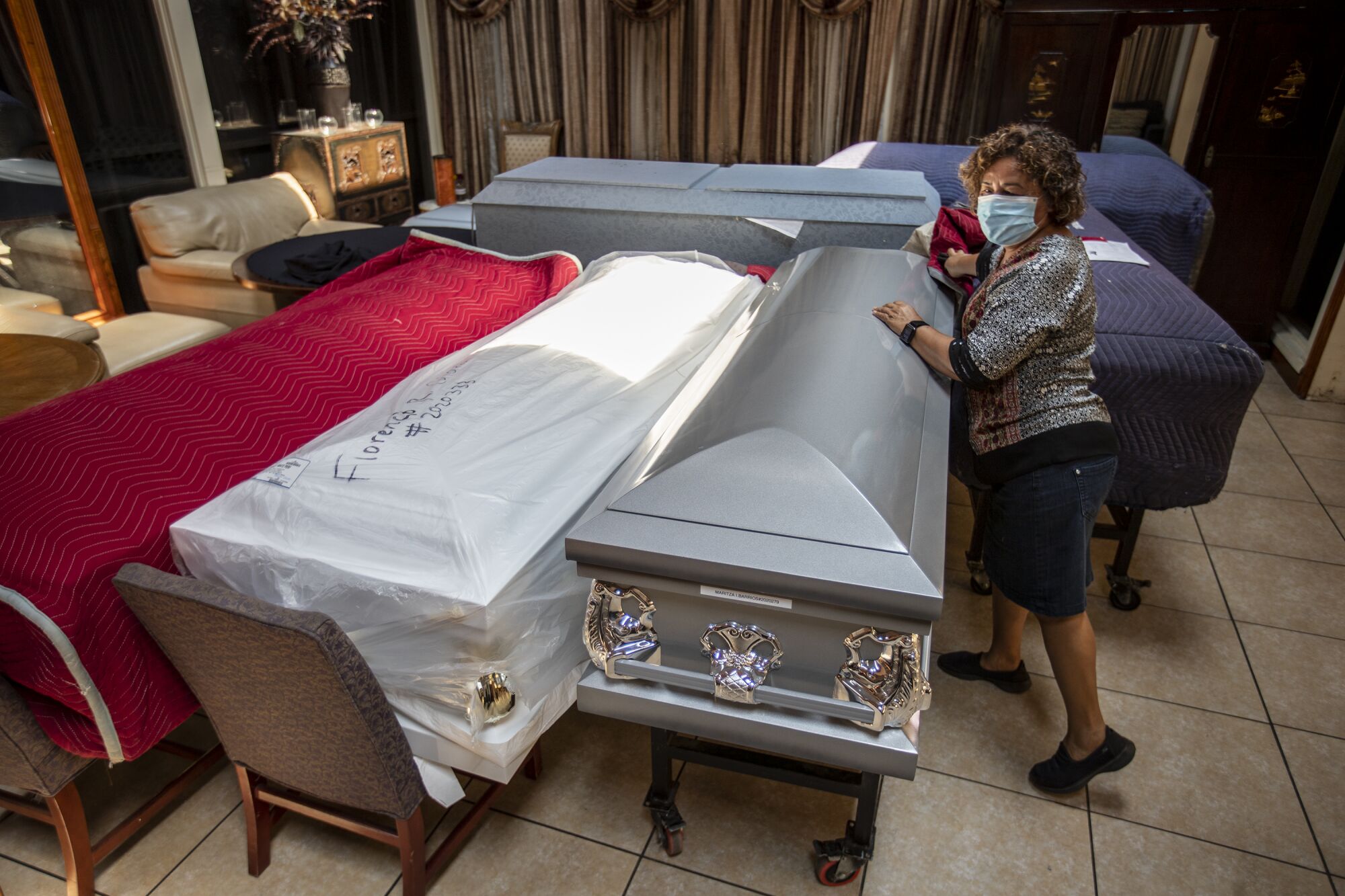 A funeral home director with caskets