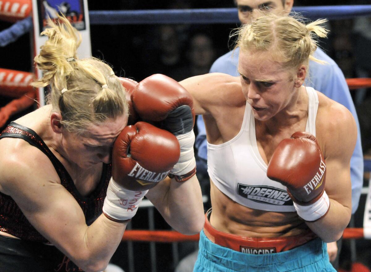 Holly Holm, right, punches Anne Sophie Mathis during an IBA and WBAN welterweight title fight in New Mexico in 2011.