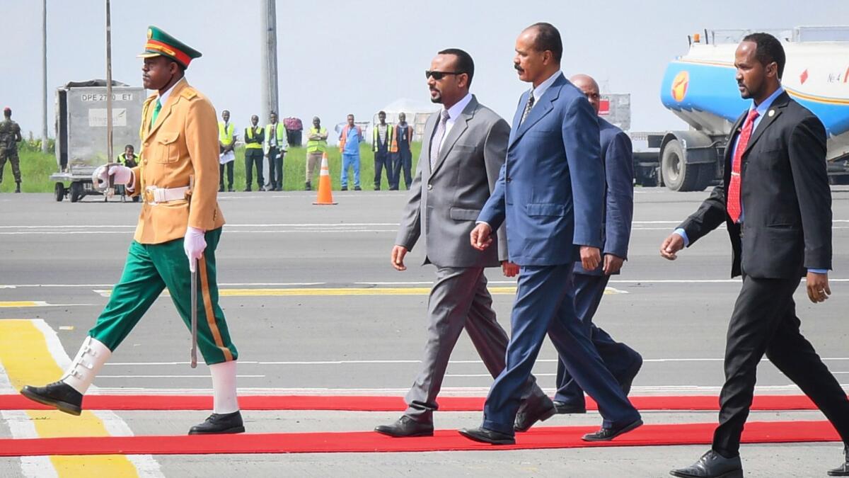 President of Eritrea Isaias Afwerki, second from right, walks with Ethiopian Prime Minister Abiy Ahmed, second from left, upon his arrival at Bole International Airport in Addis Ababa, Ethiopia, on July 14, 2018.