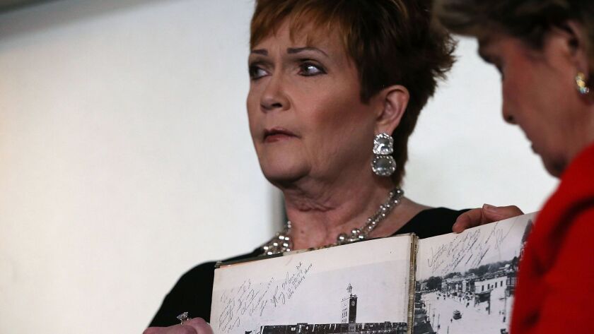 Beverly Young Nelson holds her high school yearbook on Nov. 13 at a New York news conference with her lawyer, Gloria Allred.