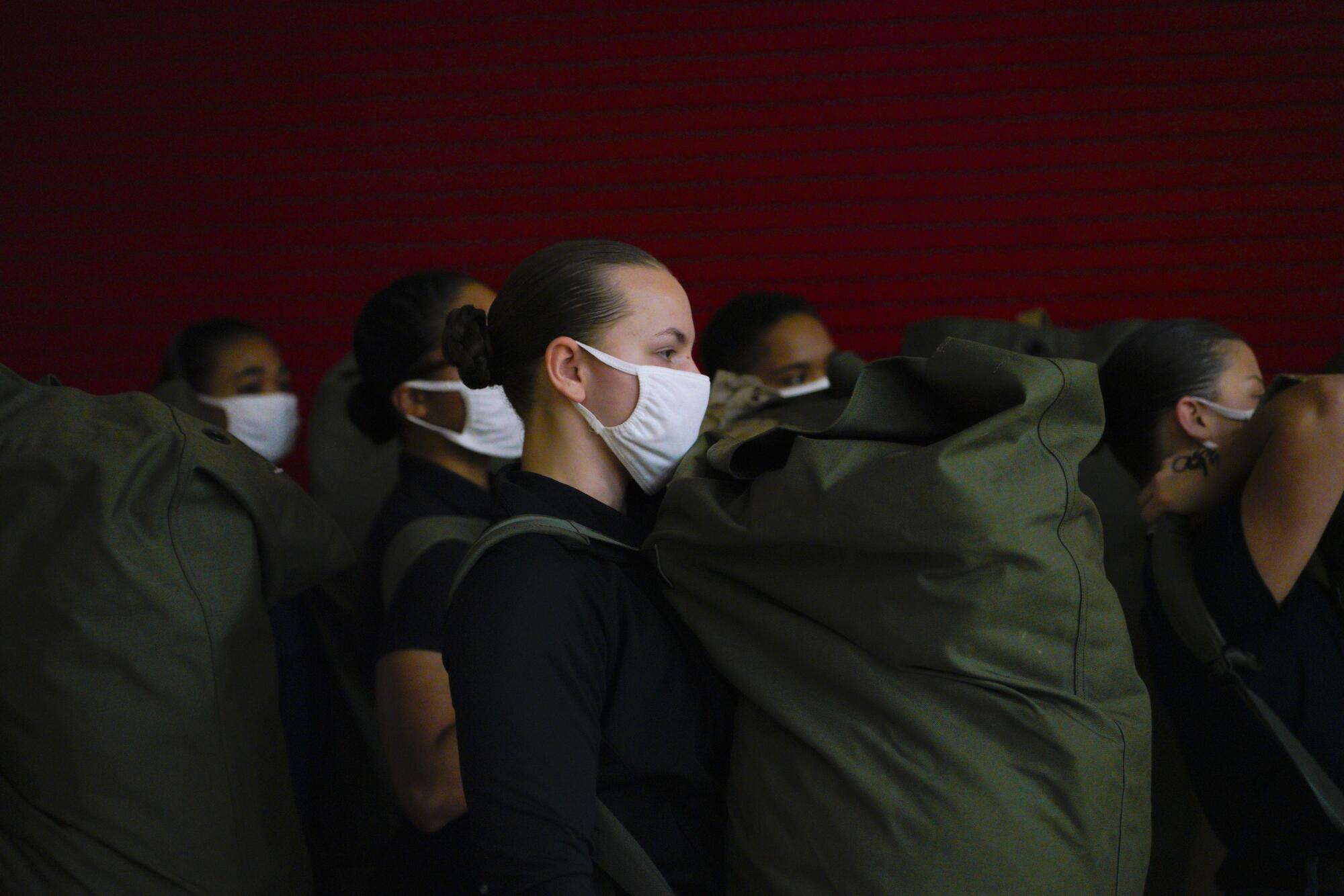 Female recruits carry their seabags.