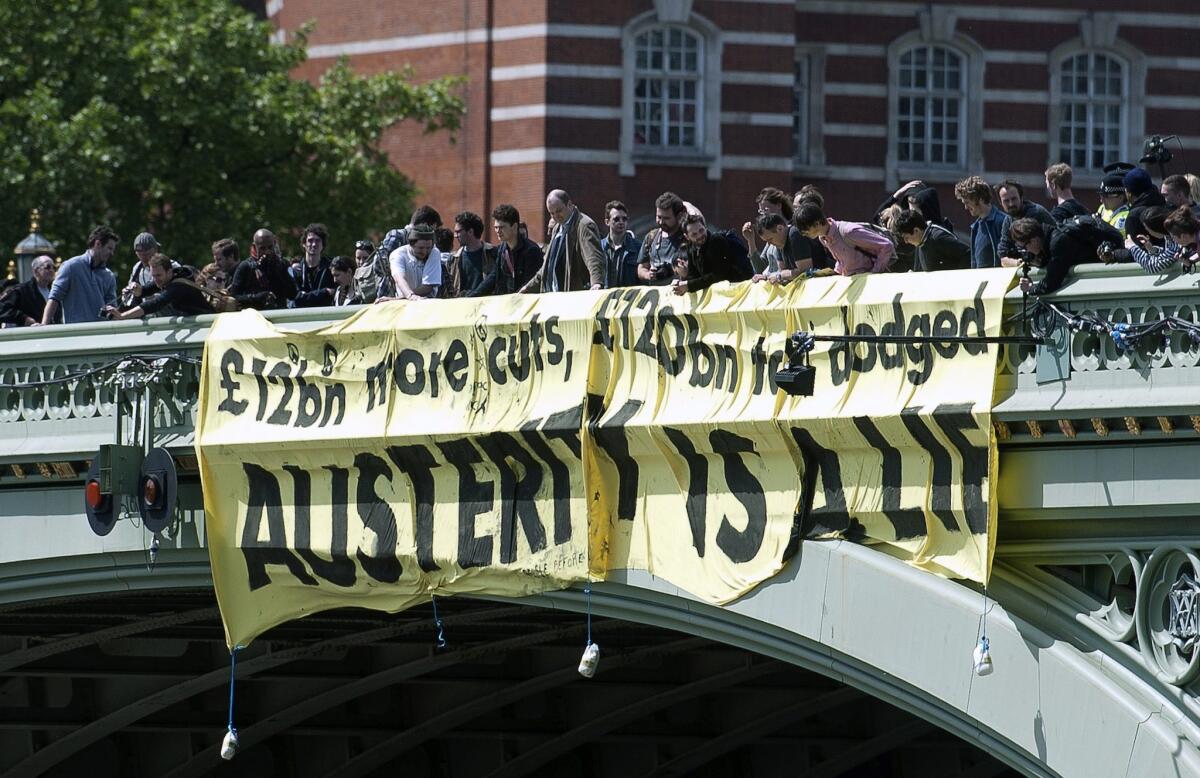 Demonstrators protest government austerity cuts last month in London.