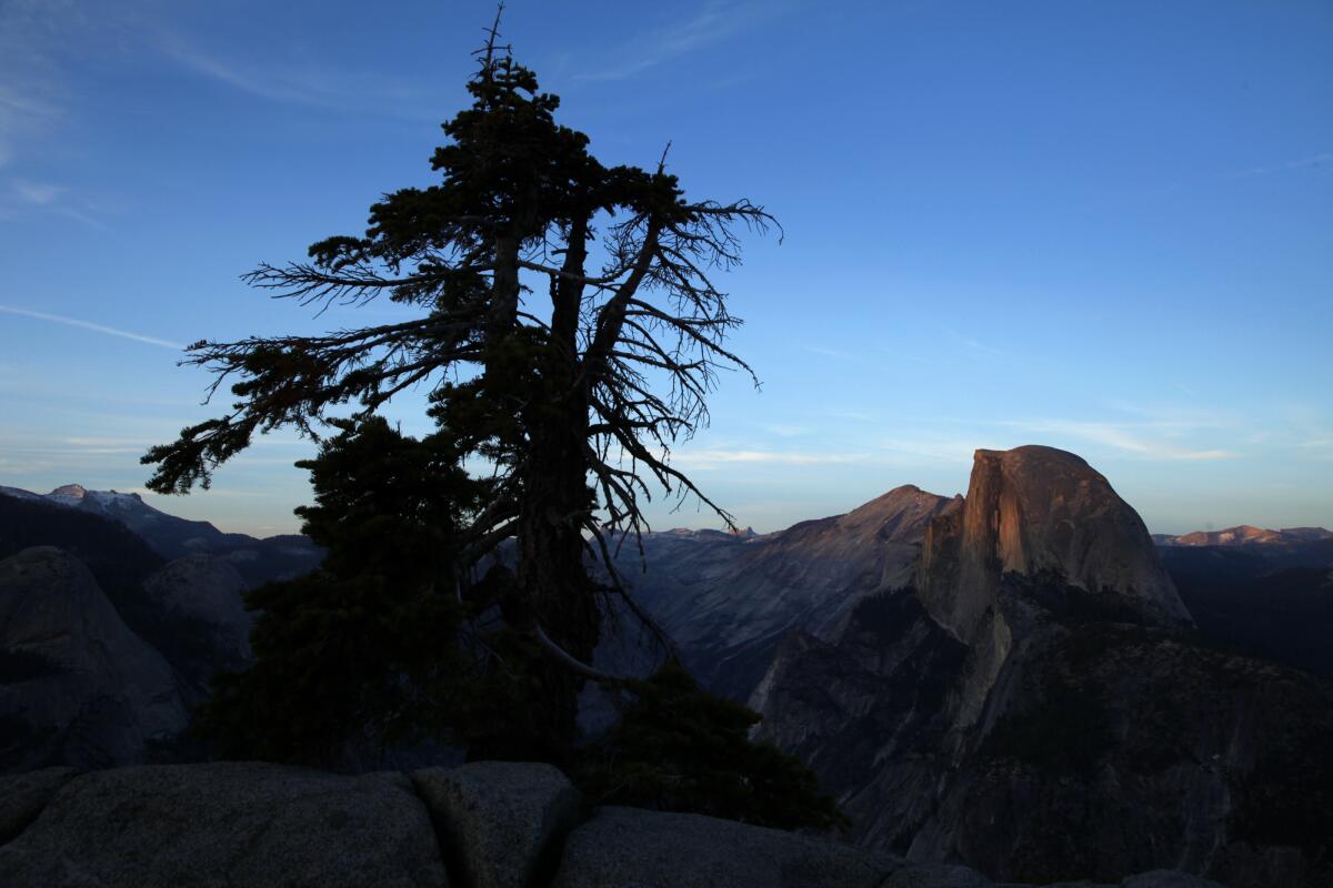 The last rays of light dance across the top of Half Dome in this view from Glacier Point in Yosemite National Park.