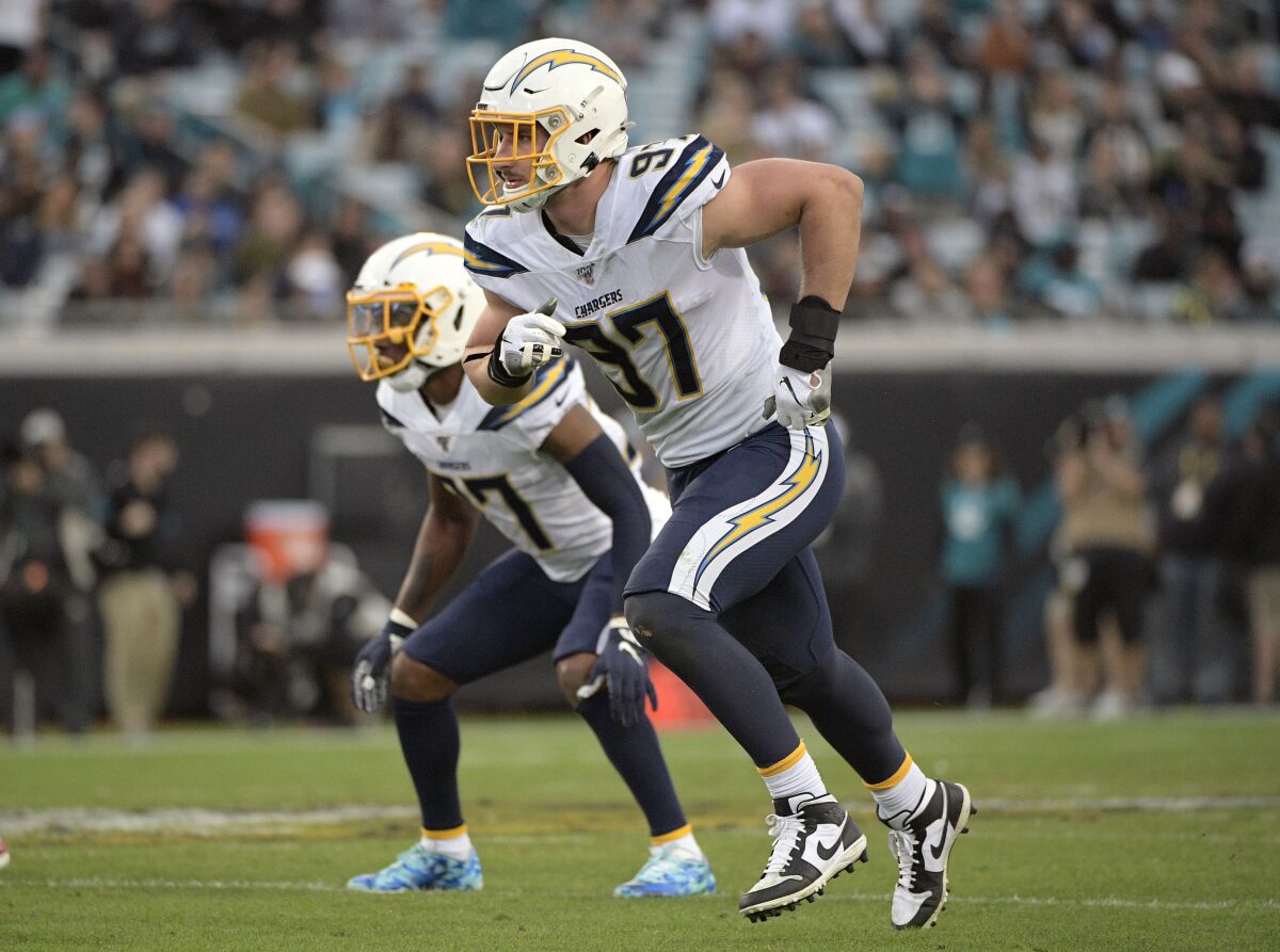 FILE - In this Sunday, Dec. 8, 2019 file photo, Los Angeles Chargers defensive end Joey Bosa (97) follows a play during the first half of an NFL football game against the Jacksonville Jaguars in Jacksonville, Fla. Defensive end Joey Bosa has agreed to a six-year, $135 million contract extension with the Los Angeles Chargers, according to multiple people familiar with the decision. The people spoke to The Associated Press on condition of anonymity Tuesday, July 28, 2020 because the contract has not been finalized.(AP Photo/Phelan M. Ebenhack, File)
