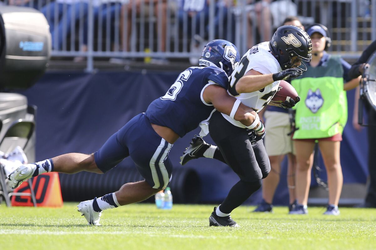 Purdue wide receiver Jackson Anthrop (33) is tackled by Connecticut linebacker Ian Swenson (6) during the first half of an NCAA football game on Saturday, Sept. 11, 2021, in East Hartford, Conn. (AP Photo/Stew Milne)