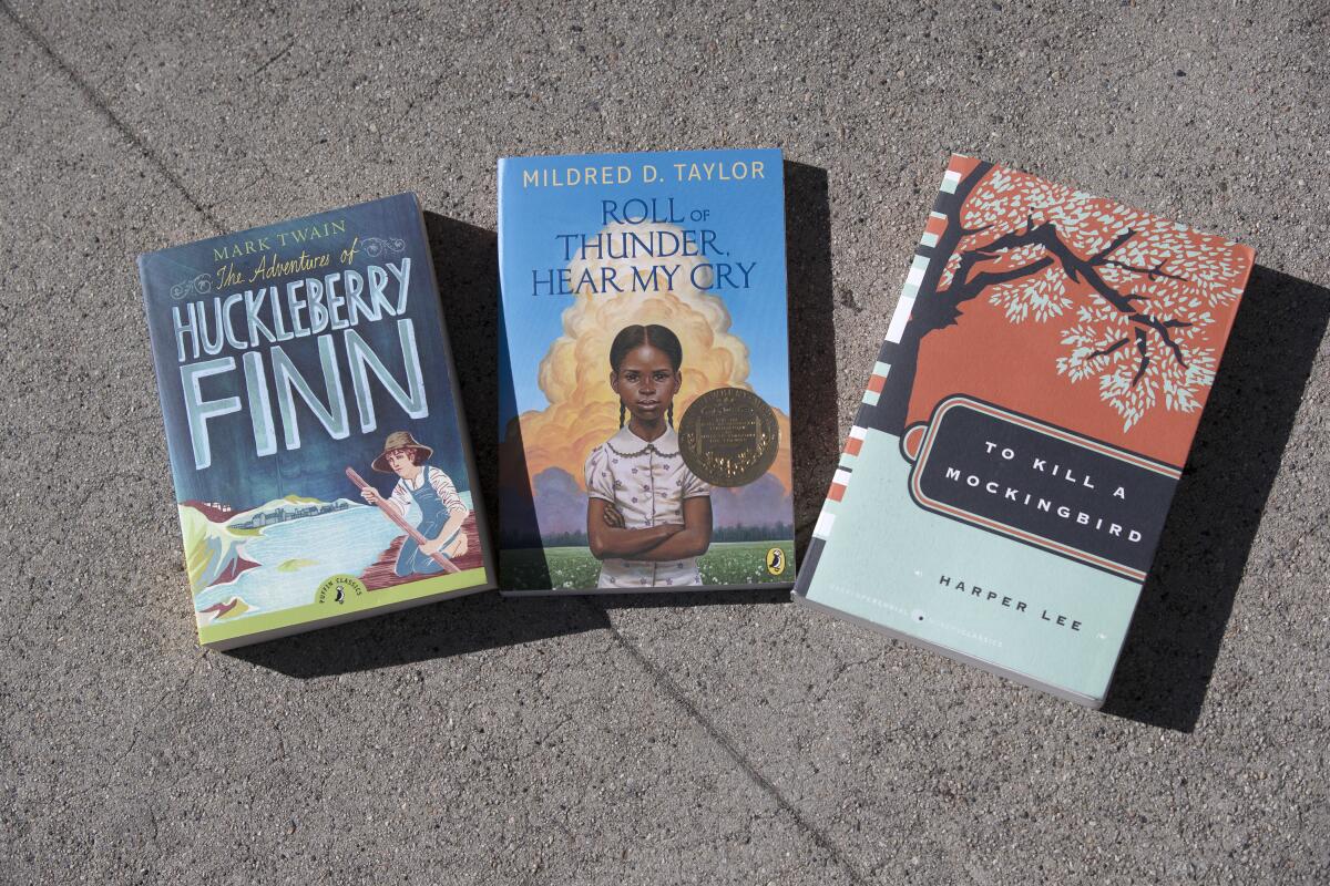 Paperback copies of "The Adventures of Huckleberry Finn," "Roll of Thunder, Hear My Cry" and "To Kill a Mockingbird."