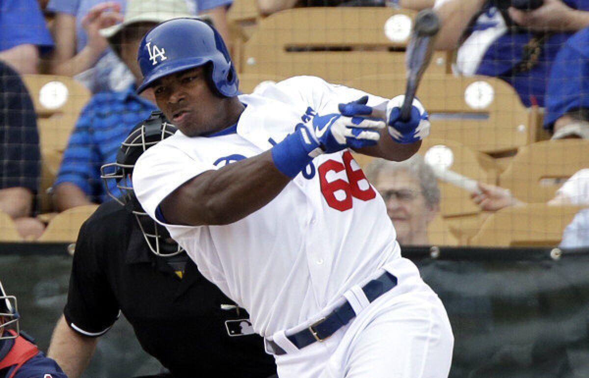 Dodgers outfielder Yasiel Puig hits a three-run home run against the Indians on March 3.