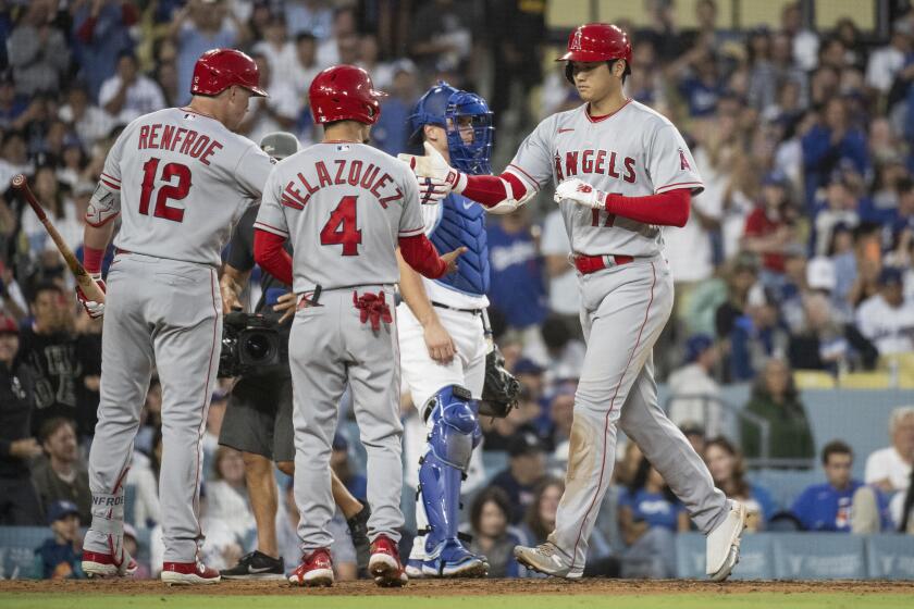 The Angels' Shohei Ohtani celebrates with Hunter Renfroe and Andrew Velazquez after hitting a homer