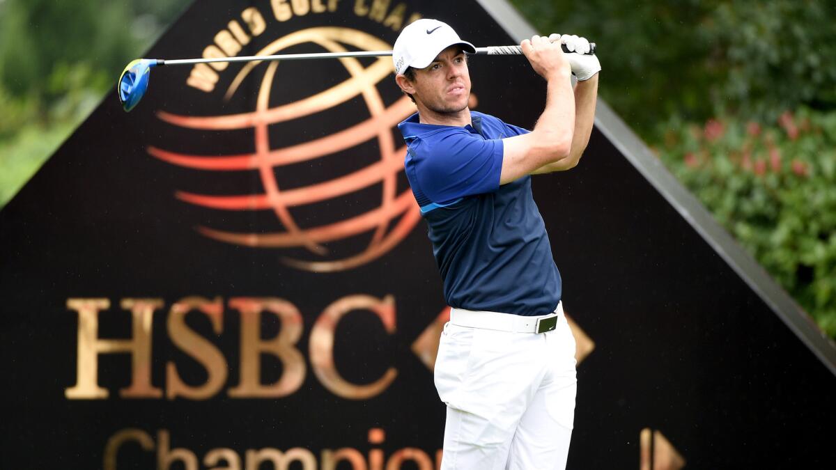 Rory McIlroy watches his tee shot at the first tee of the HSBC Champions tournament.