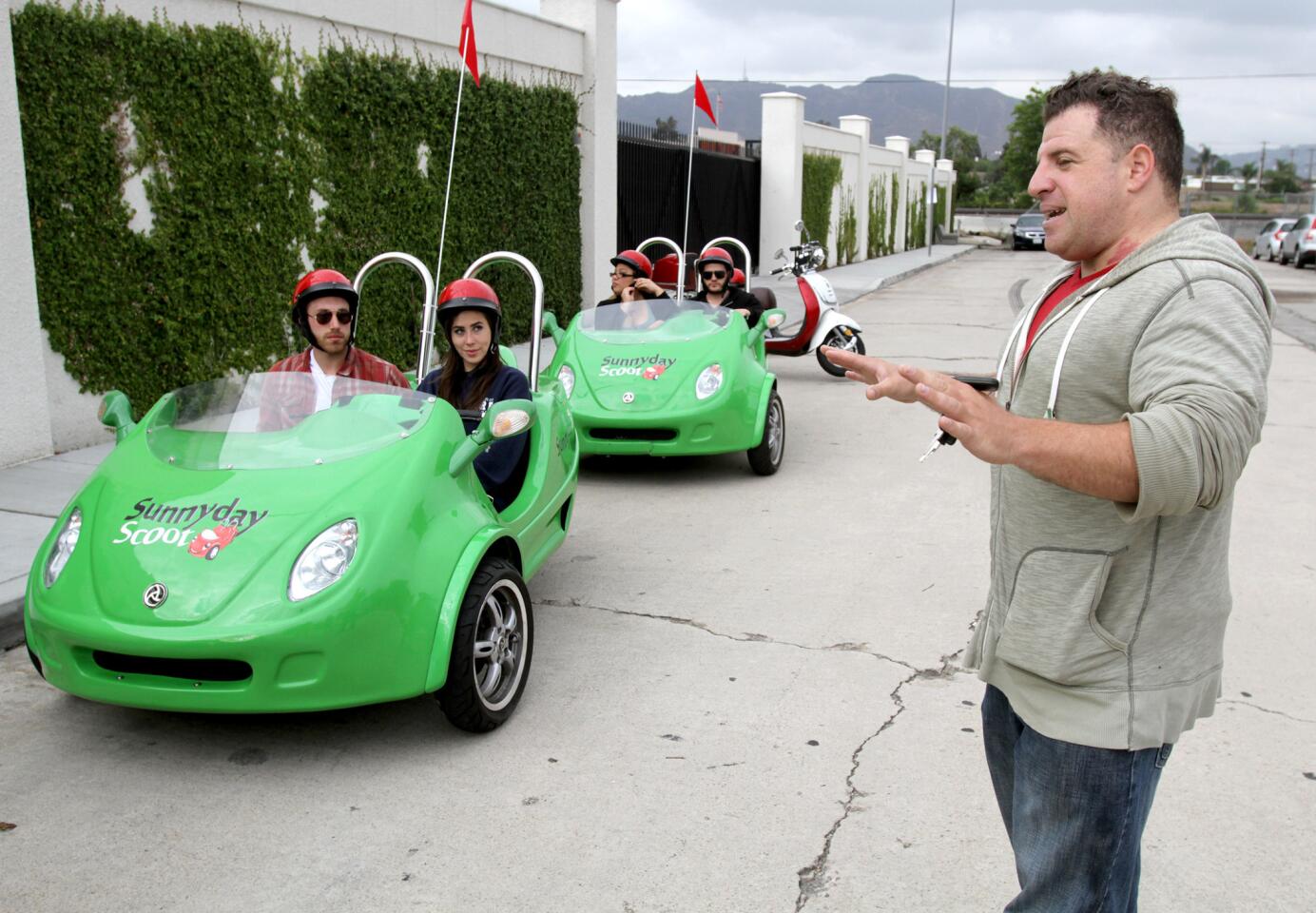 Company co-owner Michael Hunter gives a brief talk on how to operate the three-wheel scooters before a three-hour, Red Carpet tour offered by Burbank-based Sunnyday Scoot on Friday, June 5, 2015.