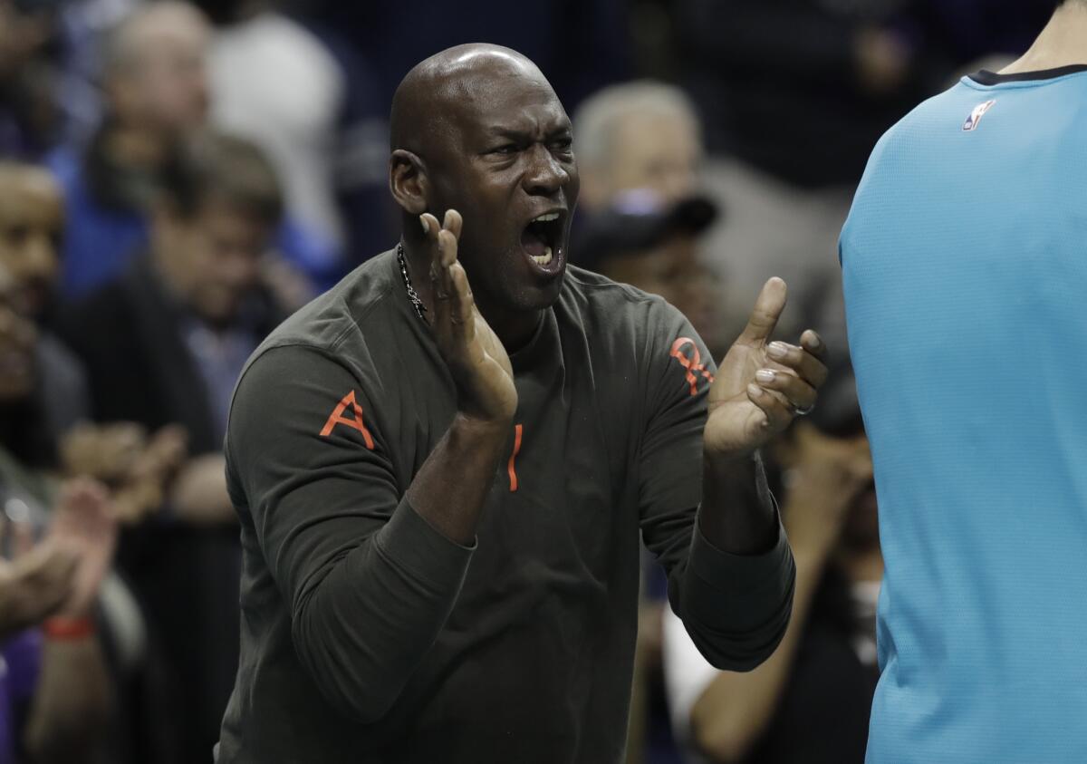 Charlotte Hornets owner Michael Jordan reacts to a play by his team against the Detroit Pistons during the second half of an NBA basketball game in Charlotte, N.C., Wednesday, Dec. 12, 2018.