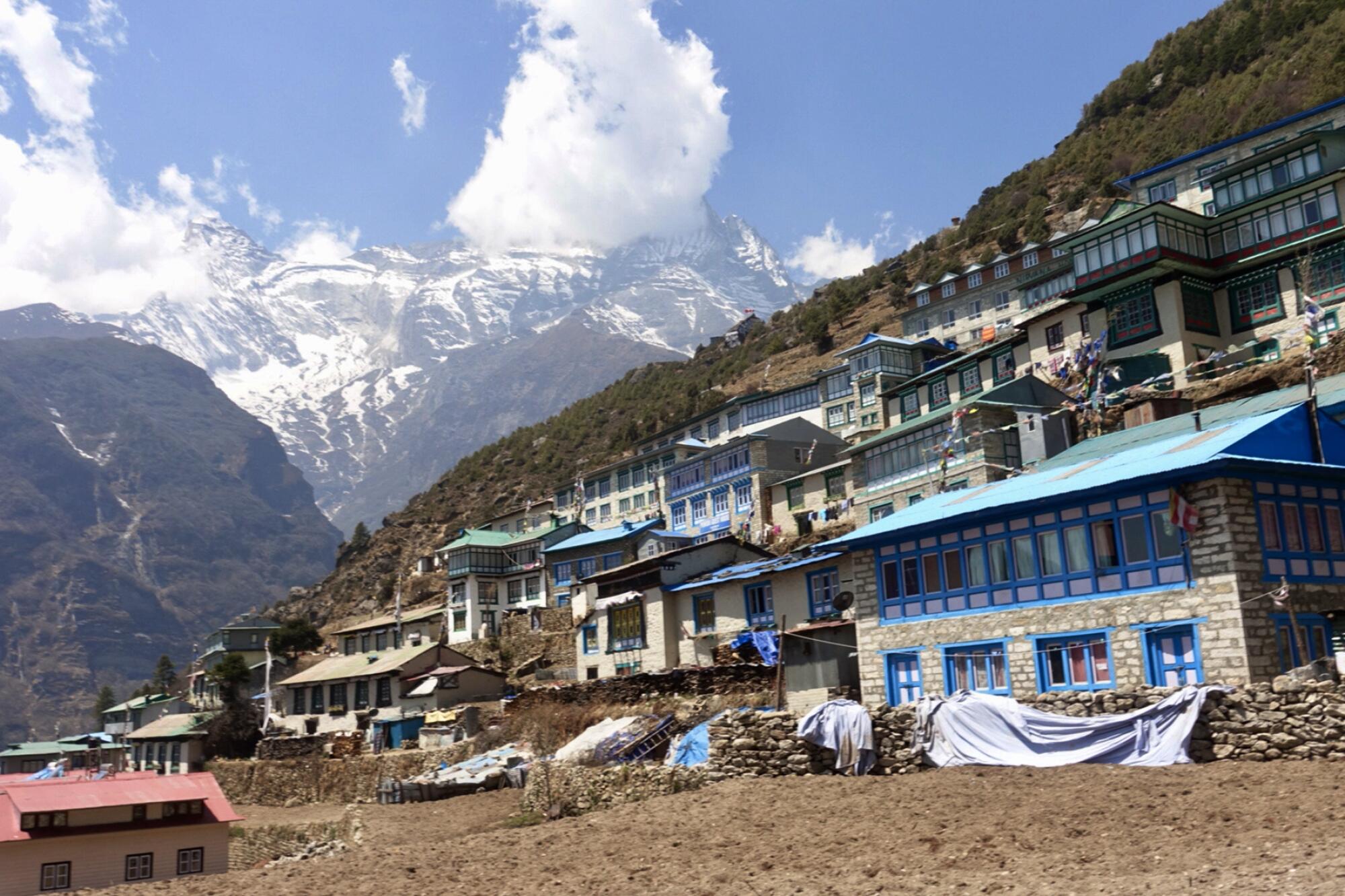 Modest buildings along a mountainside in the Himalayas