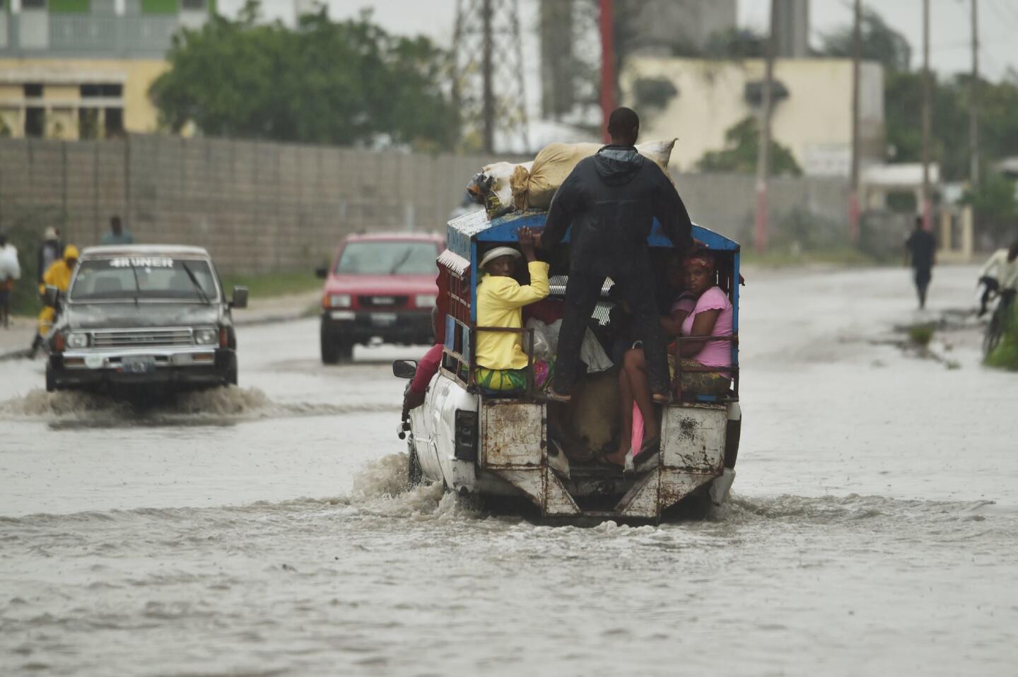 A "tap tap" truck crosses the water left by the rain after hurricane Matthew in Port-au-Prince, Haiti, on Oct. 4, 2016.