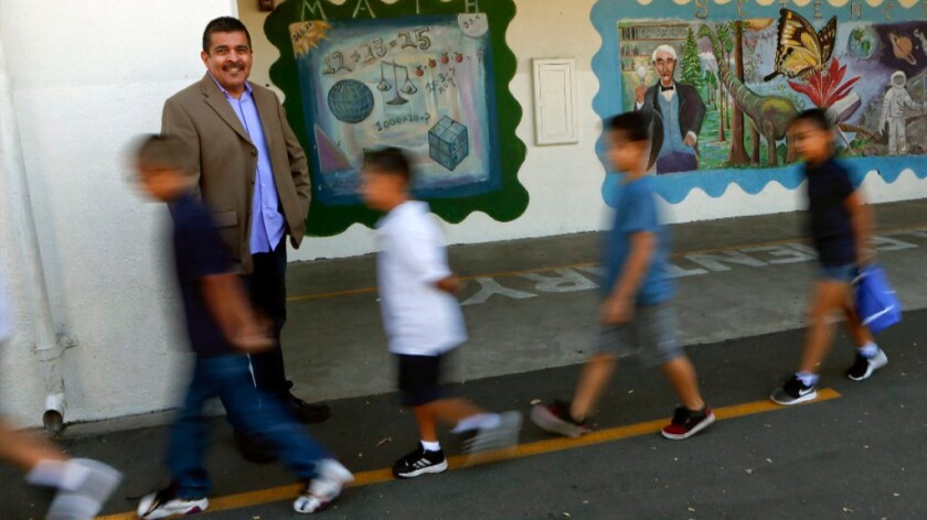 Richard Ramos, principal of Haddon Avenue STEAM Academy, watches students walk to lunch on Aug. 19.