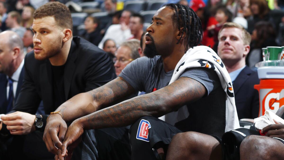 Center DeAndre Jordan watches the Clippers' game from the bench with injured forward Blake Griffin on Saturday night in Denver.