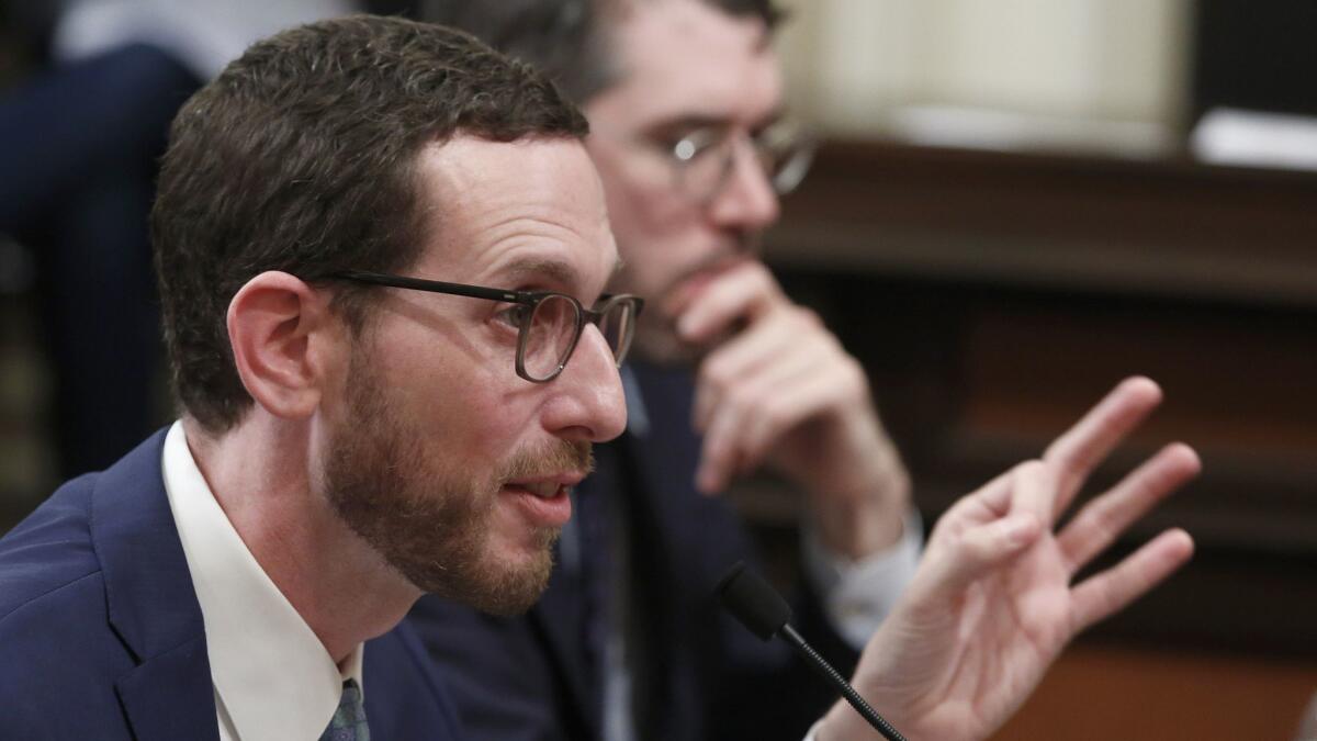 State Sen. Scott Wiener, D-San Francisco, left, discusses his housing measure, Senate Bill 50, during a committee hearing in 2019.