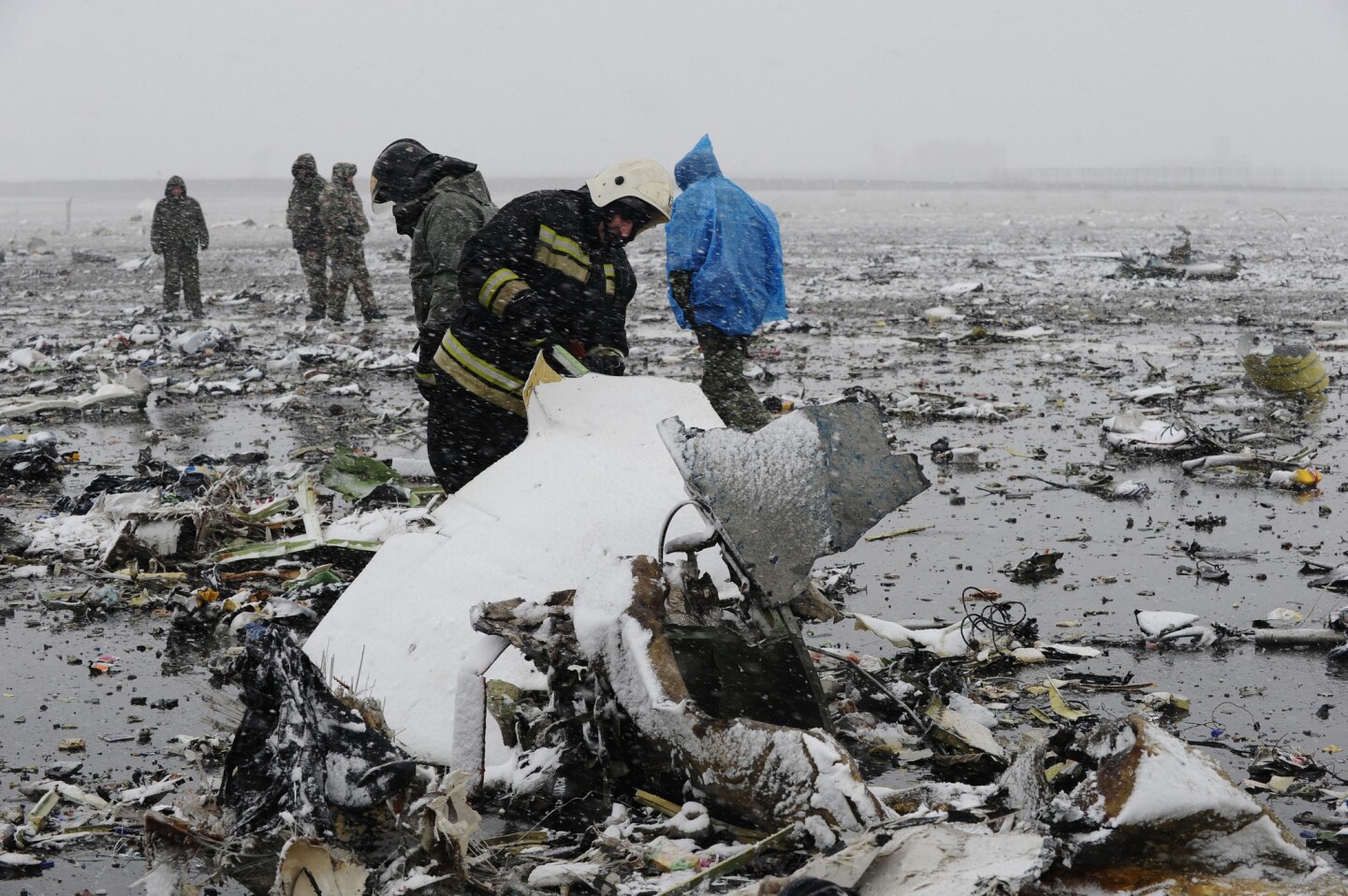 Russian emergency workers investigate the wreckage of the FlyDubai jet.