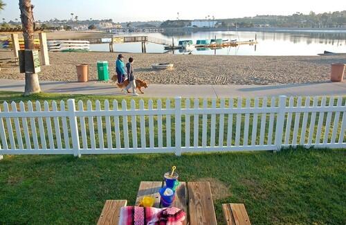 Several of the waterfront cottages have picnic tables and picket fences.
