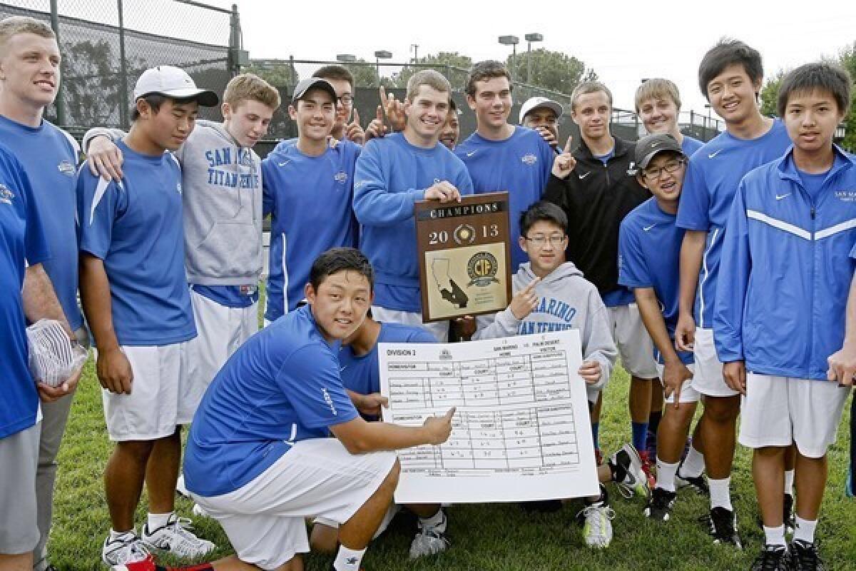 San Marino High School's tennis player James Wade, center, holds the 2013 CIF Div. II, Boys Tennis Championship trophy along with the rest of the team after defeating Palm Desert High School at the Claremont Club in Claremont, Ca., on Friday, May 17, 2013. The team won 13-5.
