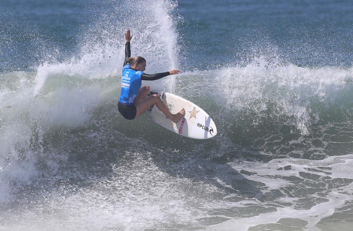 Alyssa Spencer of Carlsbad carves the face of a wave at the U.S. Open of Surfing on Friday.