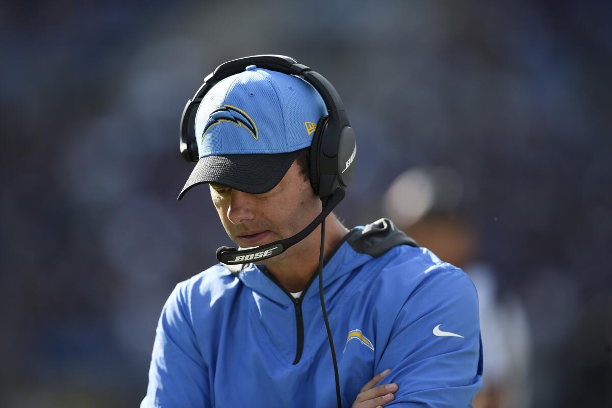Chargers head coach Brandon Staley hangs his head during blowout loss to Ravens.