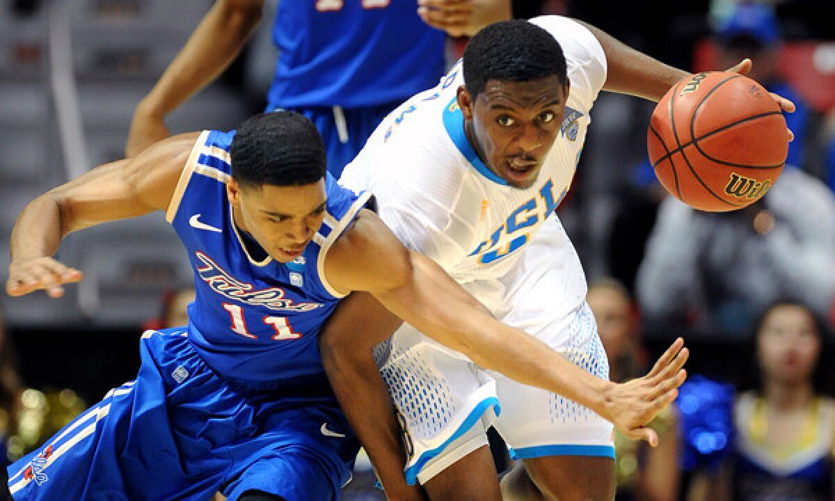 UCLA's Jordan Adams, right, steals the ball away from Tulsa's Shaquille Harrison during the second half of the Bruins' 76-59 win in the second round of the NCAA tournament Friday in San Diego.