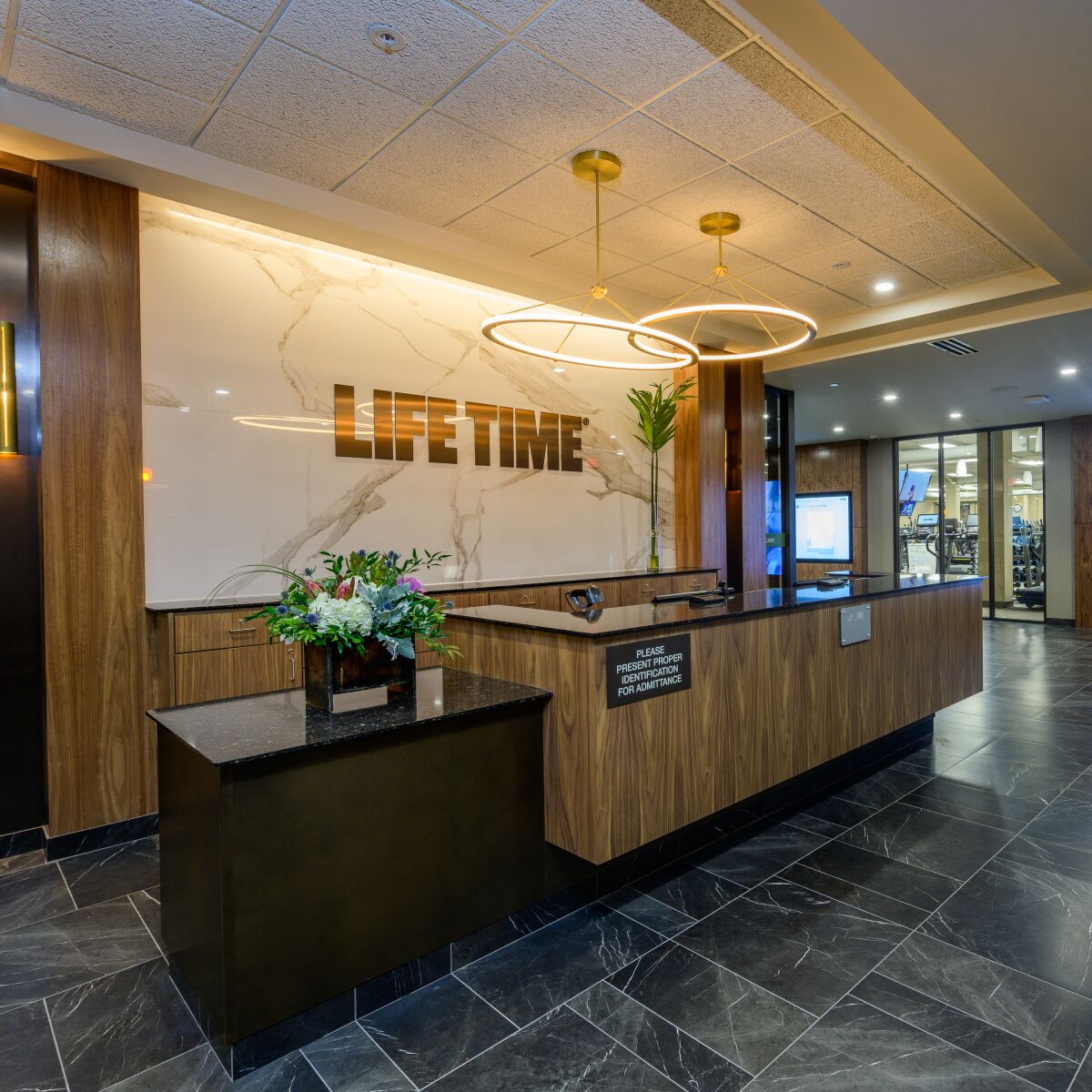 The front check-in desk welcomes guests to Life Time La Jolla.