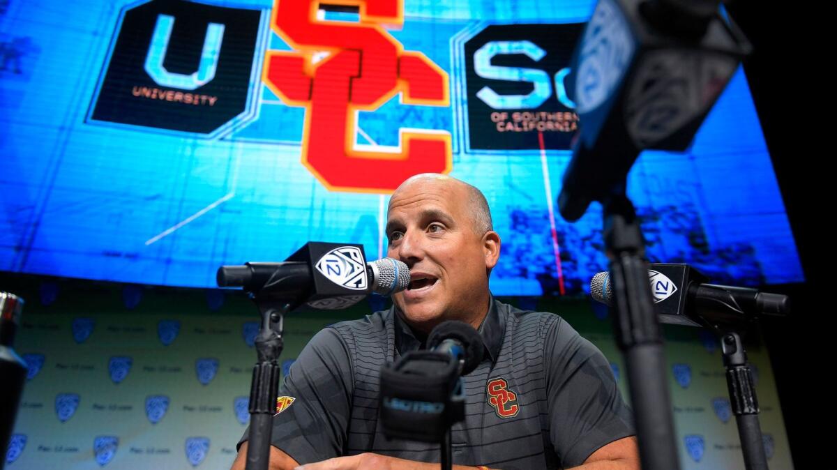 USC coach Clay Helton addresses reporters at Pac-12 media day.