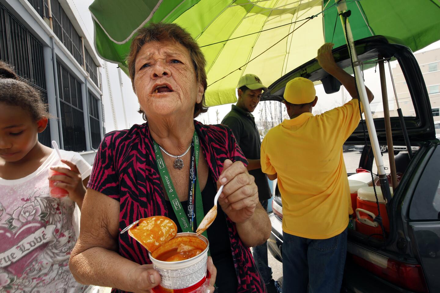 Blanca Diaz, 77, digs into a container of cold pasta she received from FEMA in Rio Grande. "I'm hung