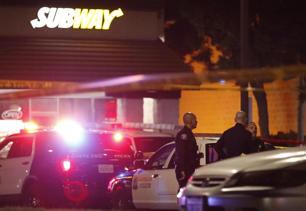 Police monitor the scene outside a Subway along First Street at Harbor Boulevard in Santa Ana, where one of several stabbings took place.