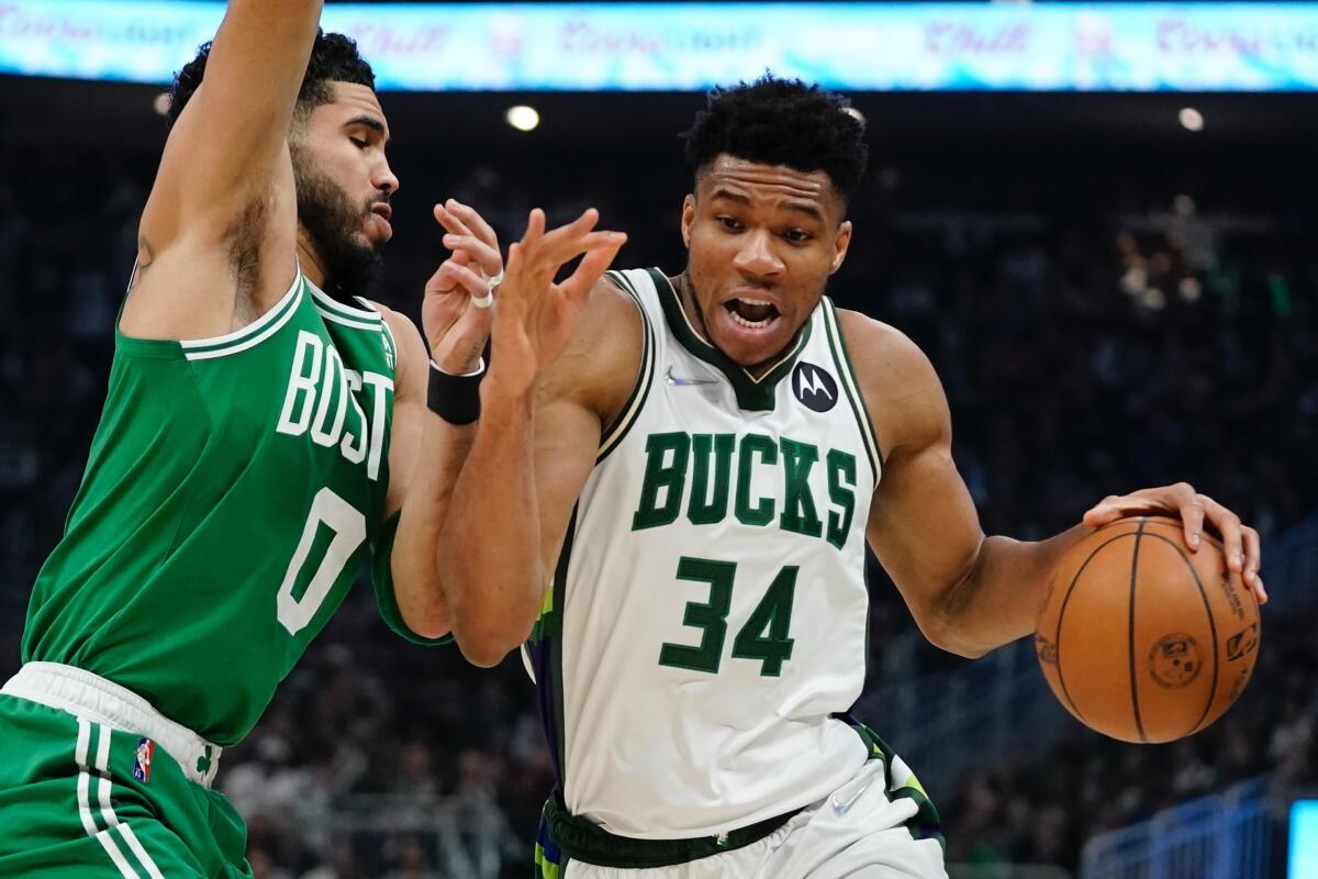 The Bucks' Giannis Antetokounmpo drives against the Celtics' Jayson Tatum during the first half of Game 3 on May 7, 2022.
