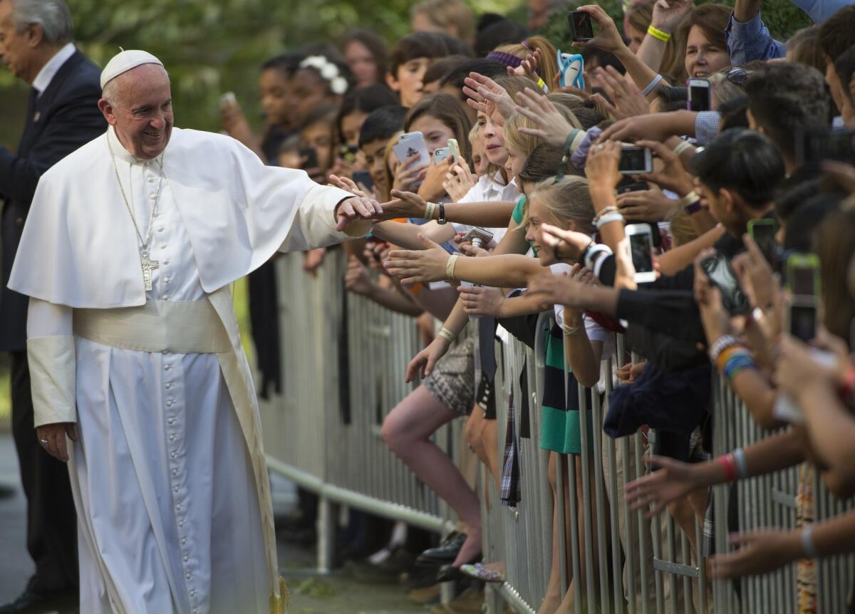 Pope Francis greets well-wishers as he leaves the Nunciature in Washington on Sept. 24.