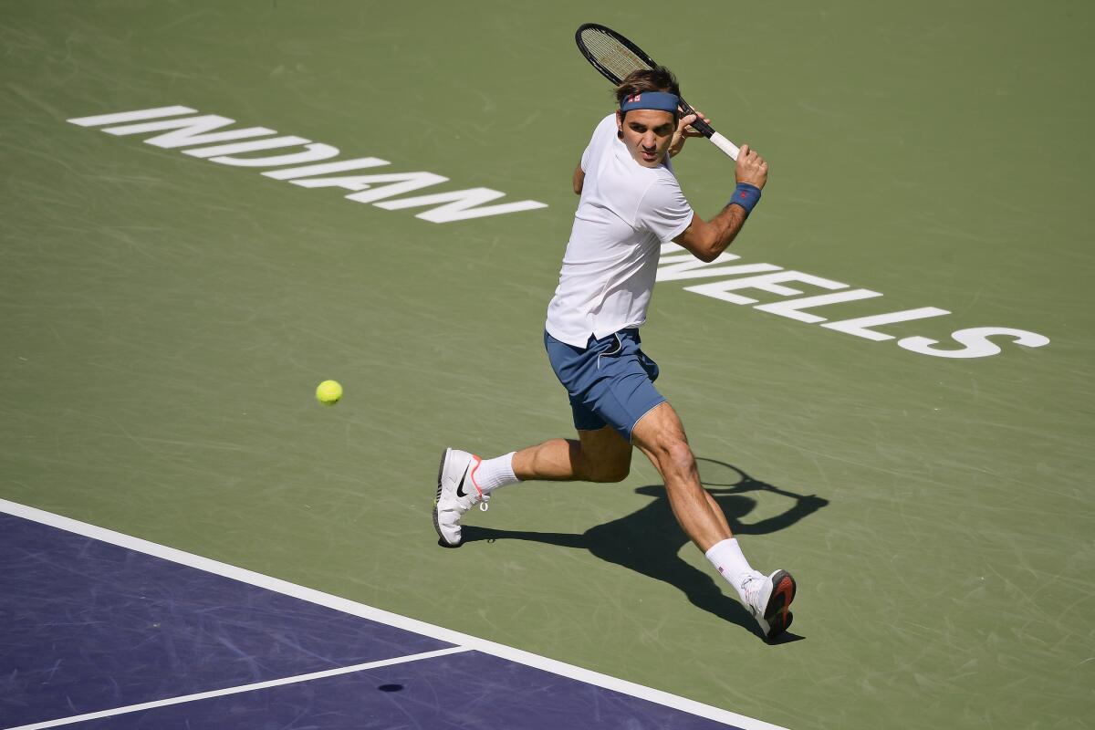 Roger Federer returns a shot during the BNP Paribas Open tennis tournament in Indian Wells.